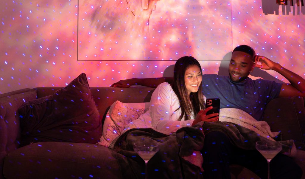 couple sitting on couch under blisslights evolve in peach