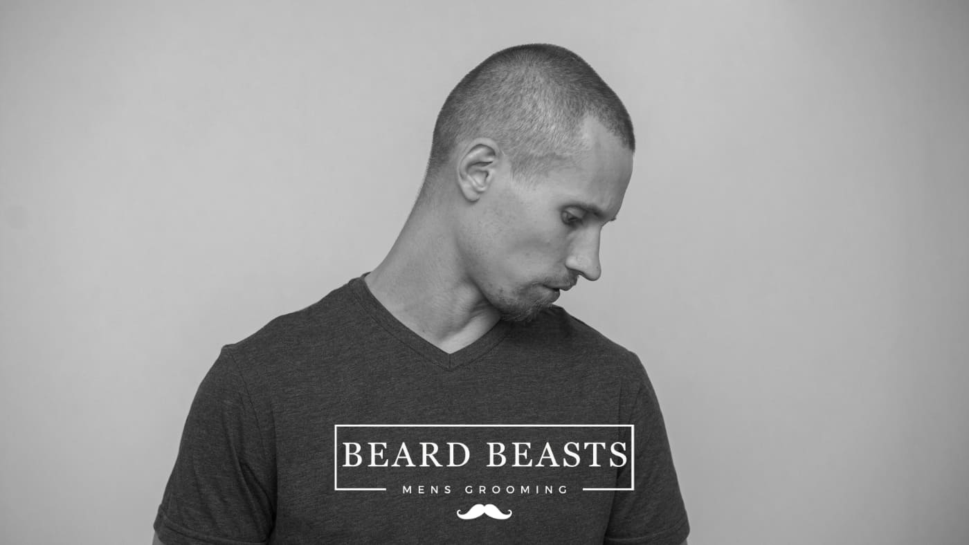 Side profile of a man sporting a fresh number 2 buzz cut for Beard Beasts men's grooming advertisement