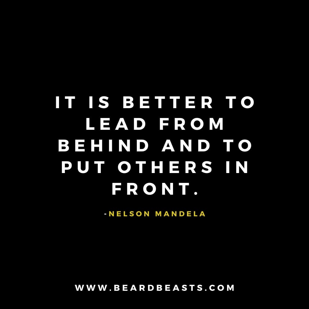 The image features a leadership quote from Nelson Mandela on a black background. The text, in bold white font, reads: "It is better to lead from behind and to put others in front." Below the quote, Nelson Mandela's name is written in small yellow font. At the bottom, the website "www.beardbeasts.com" is displayed in white text. This design highlights a thoughtful man to man quote about leadership, emphasizing the value of humility and empowering others to take the spotlight while leading from behind.