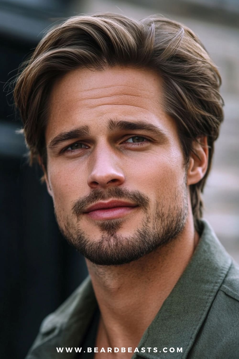 A man with a stylish layered medium cut hairstyle is seen in this close-up image, featuring soft, voluminous layers that create movement and texture.