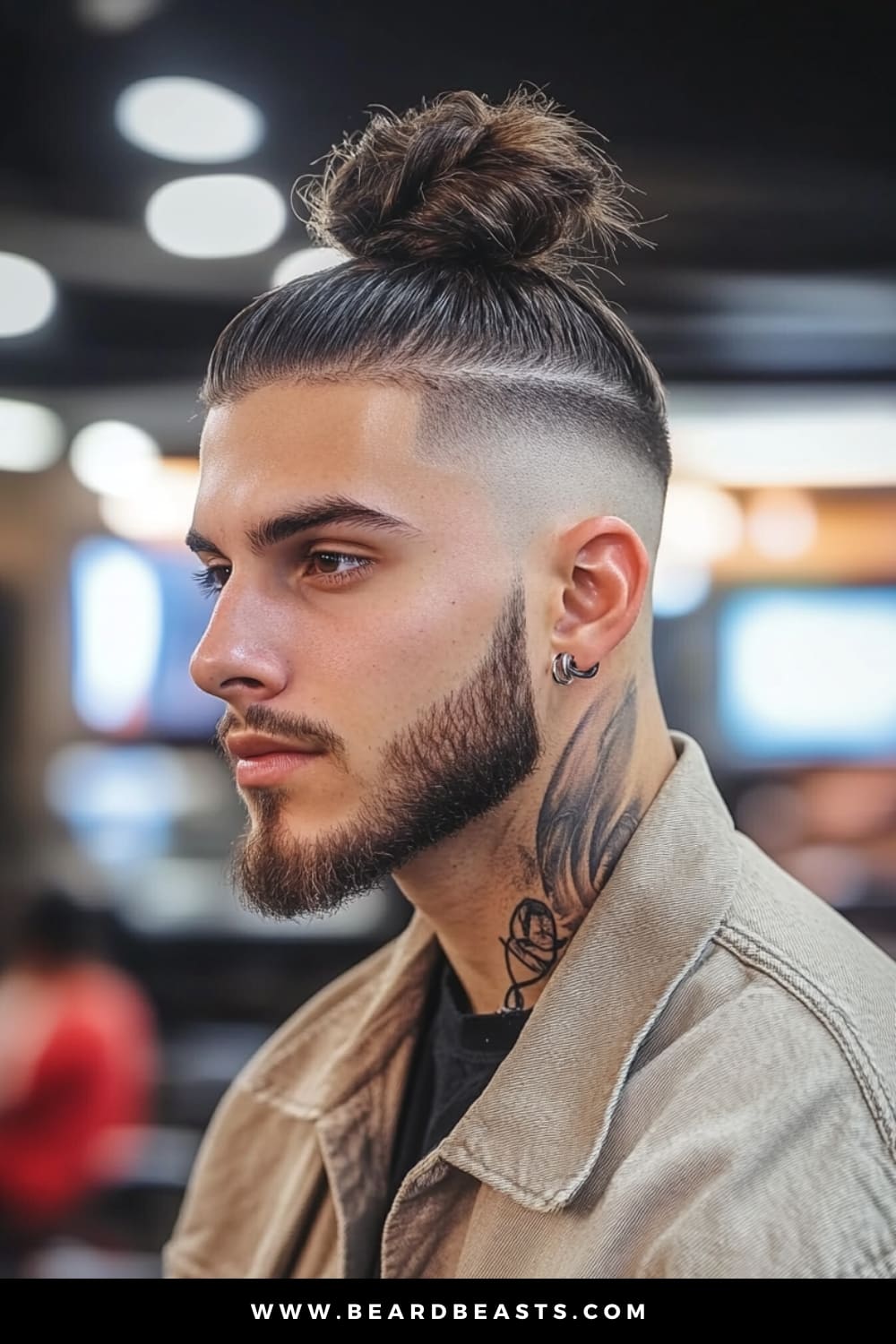 Side profile of a young man with a Man Bun Undercut, showcasing a popular style in men's short on sides, long on top haircuts. The long hair is neatly tied into a bun at the crown, while the sides are shaved close, creating a striking contrast that highlights the clean lines and modern appeal of this trendy hairstyle.