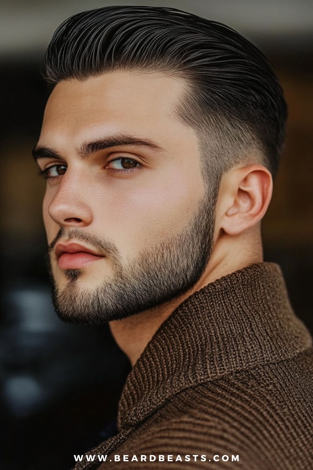 A young man confidently showcases a sleek slick back, a popular choice among medium hairstyles for men with thick hair. His thick hair is combed back smoothly, creating a polished and refined look that accentuates the volume and texture of his hair. The sides are neatly tapered, enhancing the clean and sharp appearance of this classic hairstyle. He sports a well-groomed beard and is dressed in a stylish brown sweater, adding to the sophisticated yet modern vibe.