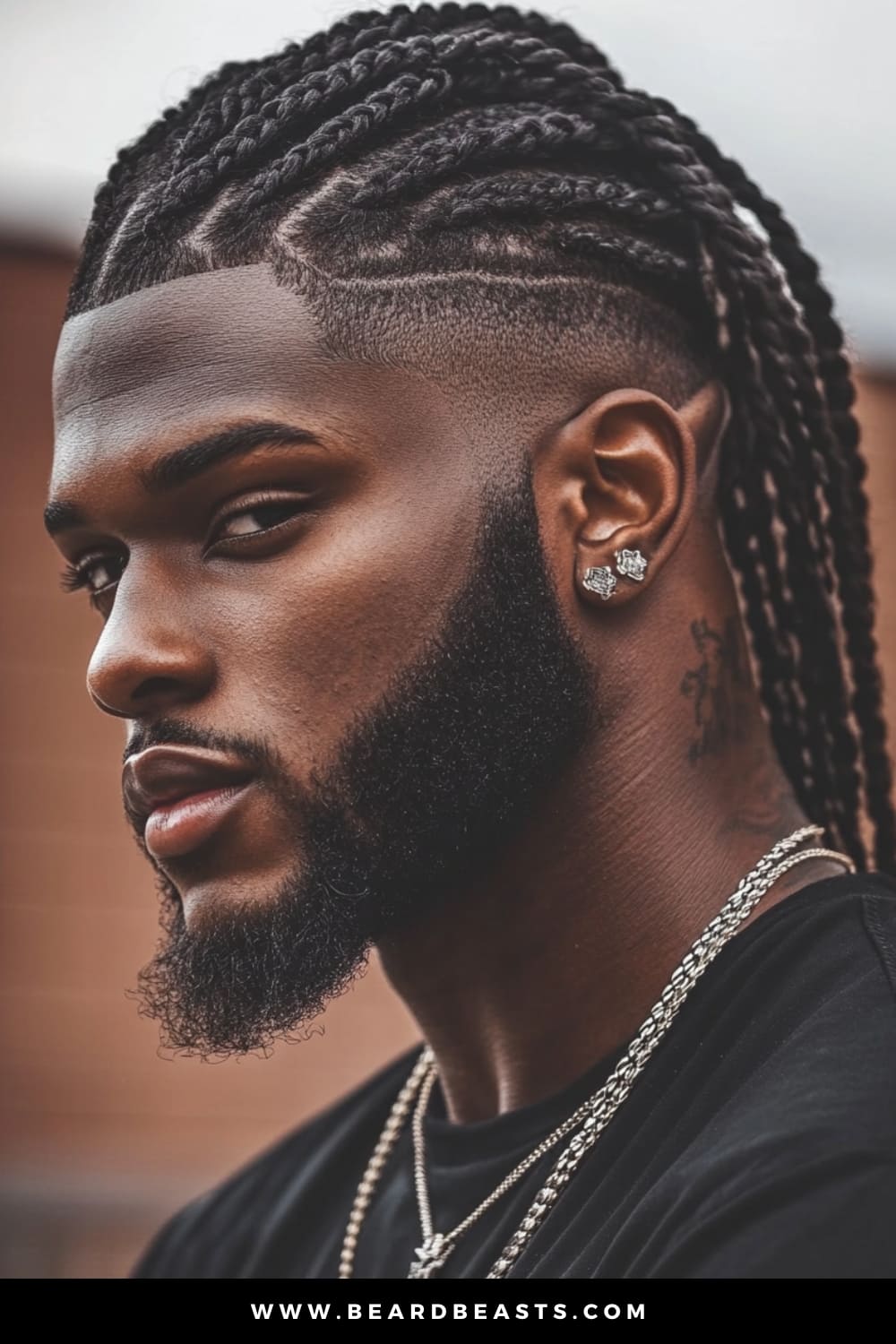 Close-up of a young man with Shaved Sides Cornrows, an eye-catching style within men's short on sides, long on top haircuts. The intricate cornrows on top create a bold and stylish look, while the shaved sides offer a sharp, clean contrast, making it a powerful statement of modern grooming and traditional style.