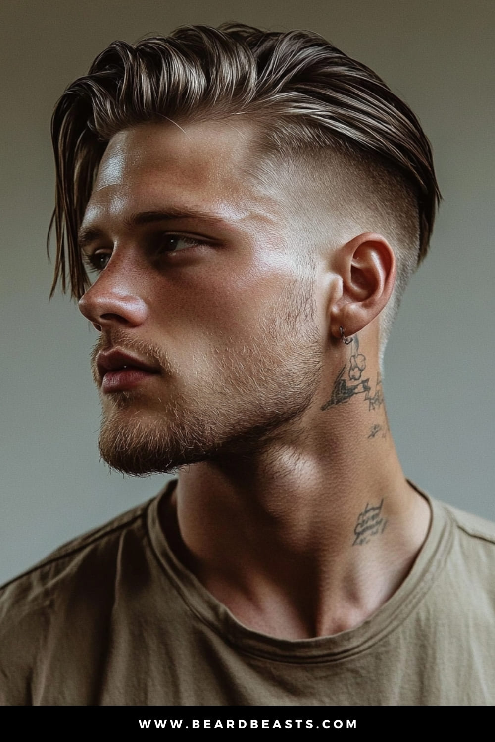 Profile view of a young man with a Slicked Back Undercut, featuring a long top combed back for a sleek, polished look, contrasted by closely shaved sides. The hairstyle accentuates the natural texture of the hair, offering a modern and edgy appearance.