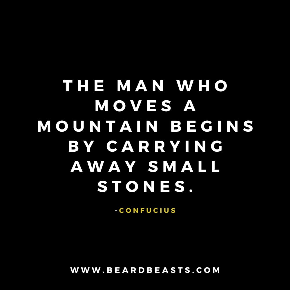 The image features a thoughtful quote from Confucius on a black background. The text, in bold white font, reads: "The man who moves a mountain begins by carrying away small stones." Below the quote, Confucius' name is written in small yellow font. At the bottom, the website "www.beardbeasts.com" is displayed in white text. This design showcases a wise man to man quote about patience, persistence, and the power of small steps toward achieving big goals.