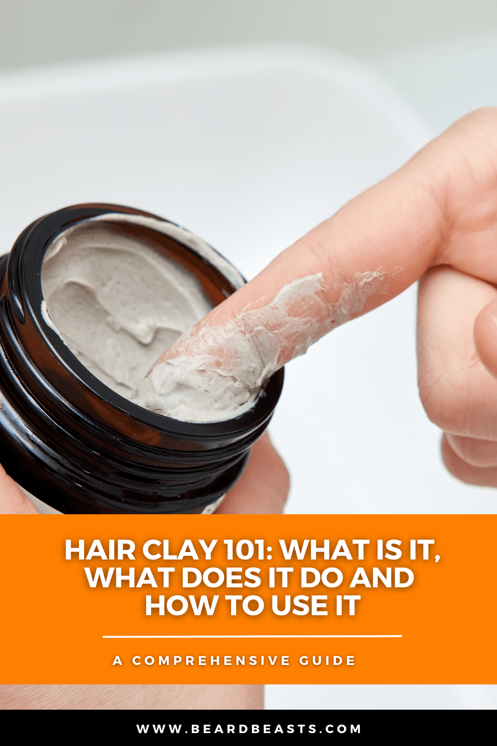 Close-up of a person scooping a dime-sized amount of hair clay from a jar, illustrating the topic 'Hair Clay 101: What Is It, What Does It Do, and How To Use It.' The image emphasizes the proper usage and texture of hair clay, perfect for achieving a natural, matte finish. Accompanied by the text, 'A Comprehensive Guide,' highlighting the focus on hair clay usage and benefits.