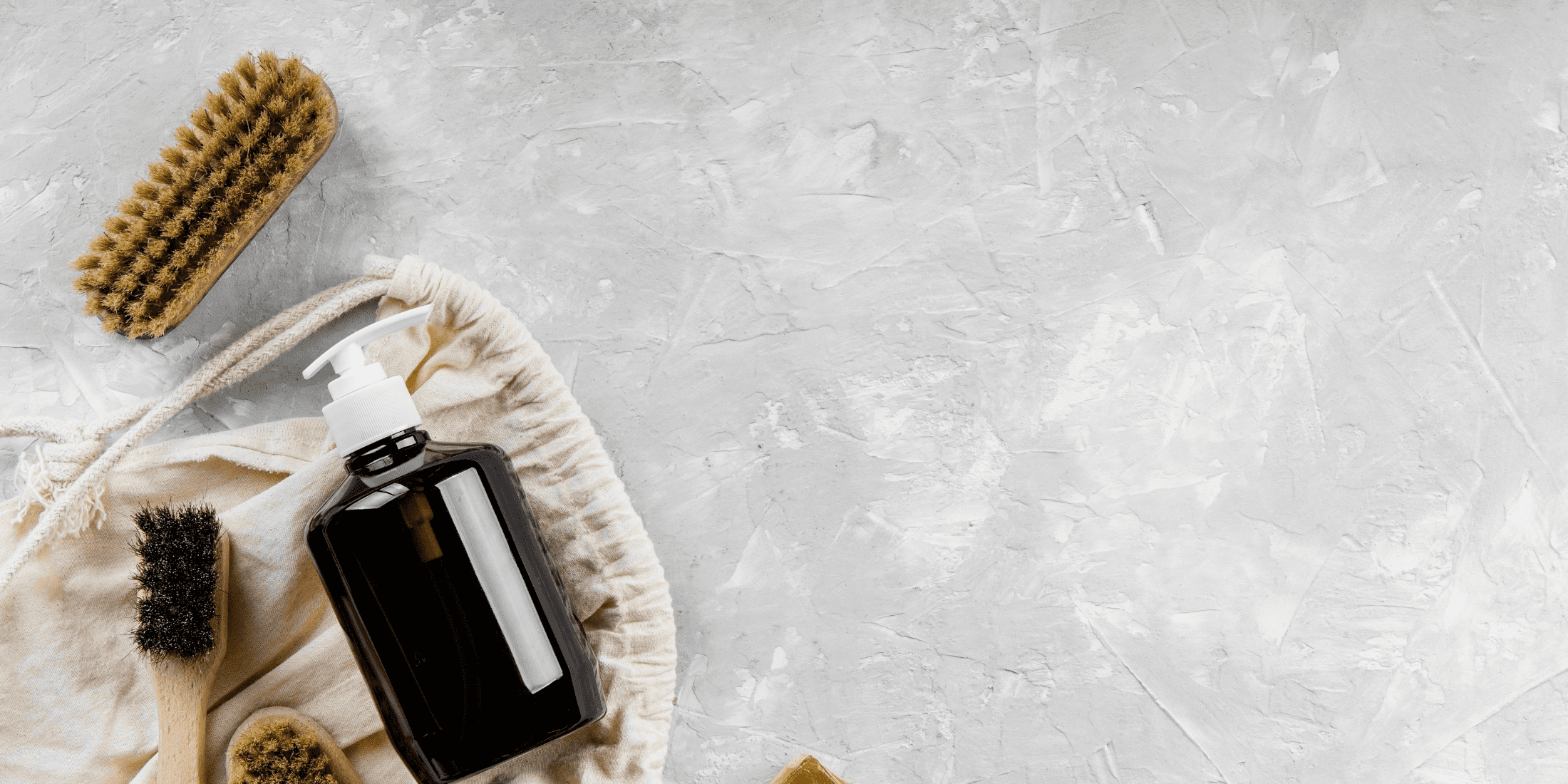 Essential tools for cleaning hair clippers: blade oil, stiff-bristle brush, and cleaning solution.